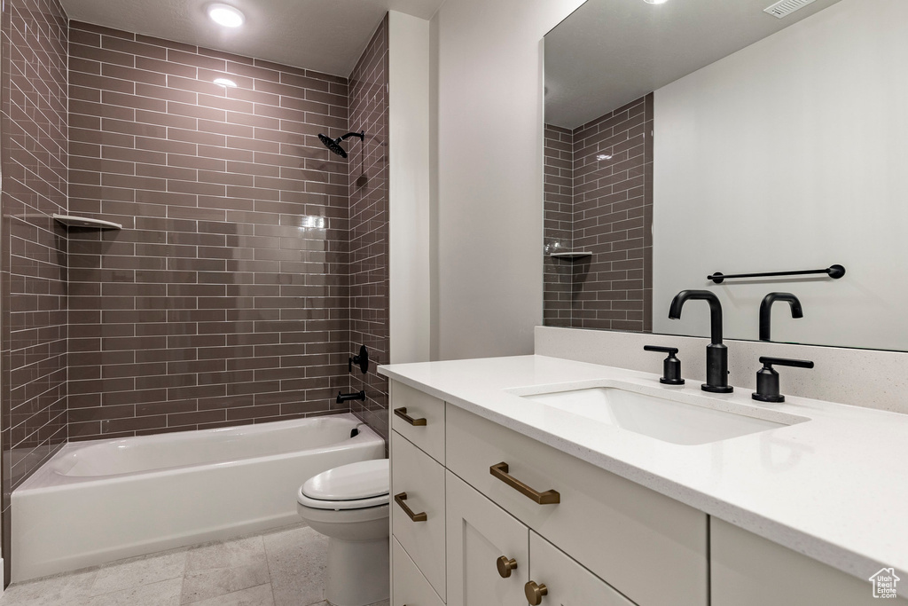 Bathroom featuring toilet, shower / tub combination, vanity, and recessed lighting