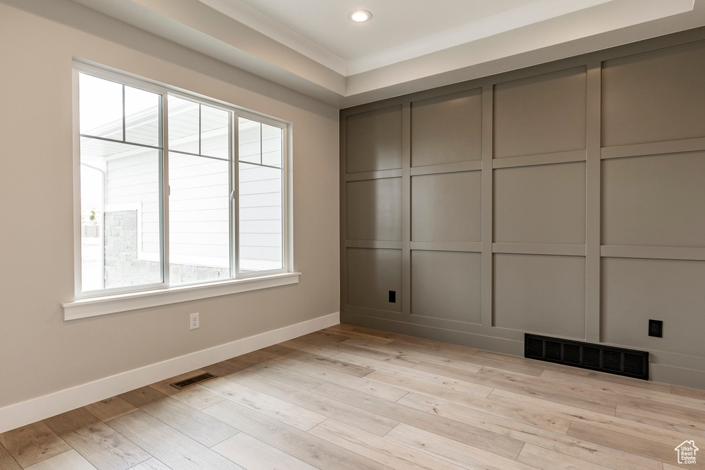 Empty room featuring baseboards, light wood finished floors, and recessed lighting
