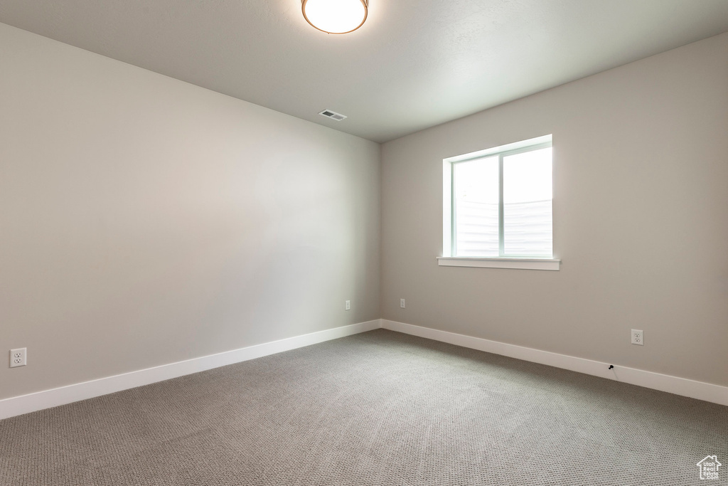 Spare room with carpet flooring and baseboards