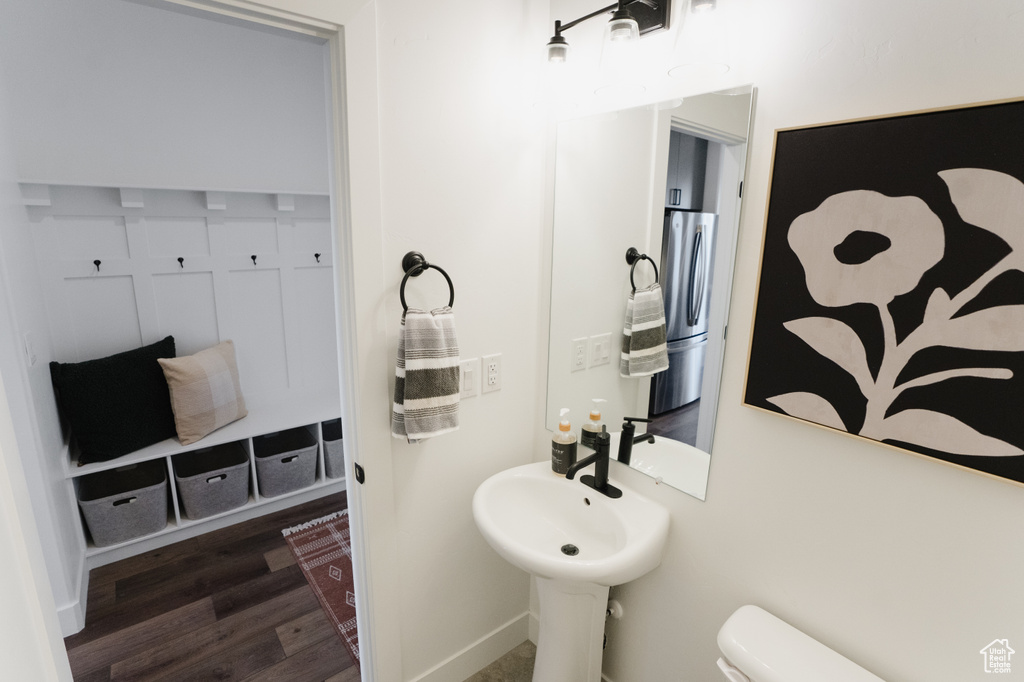Bathroom with hardwood / wood-style flooring and toilet
