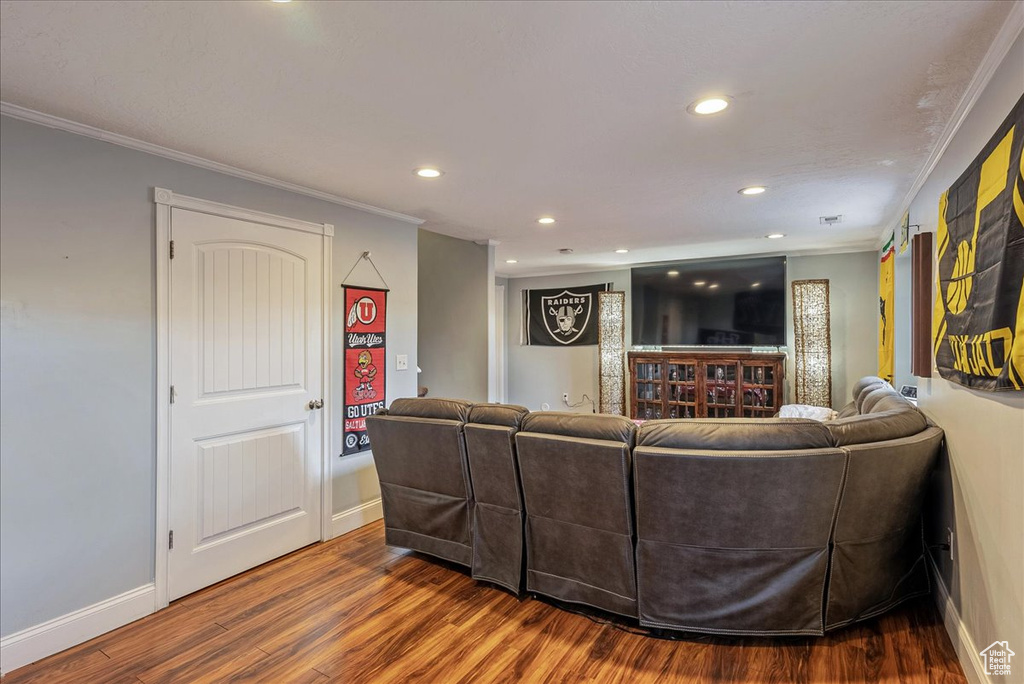 Living room featuring crown molding and hardwood / wood-style flooring