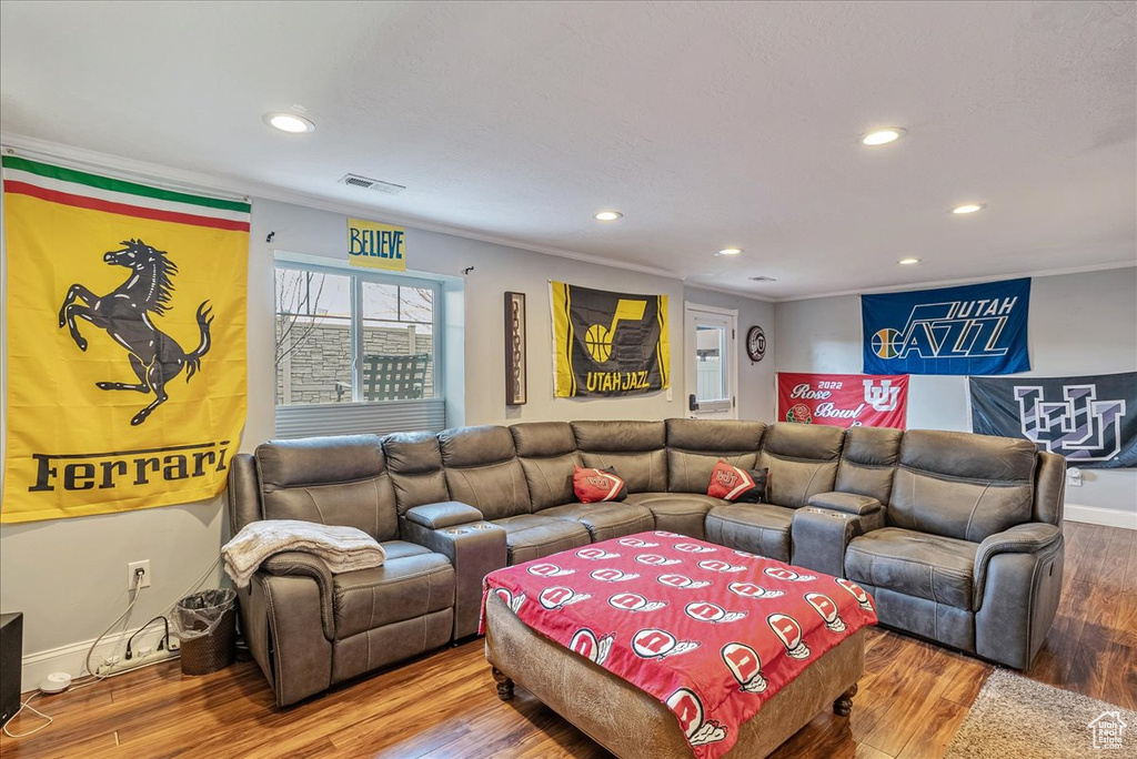 Living room featuring hardwood / wood-style floors and crown molding