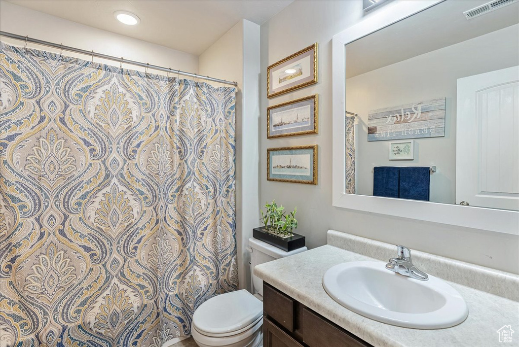 Bathroom featuring vanity and toilet