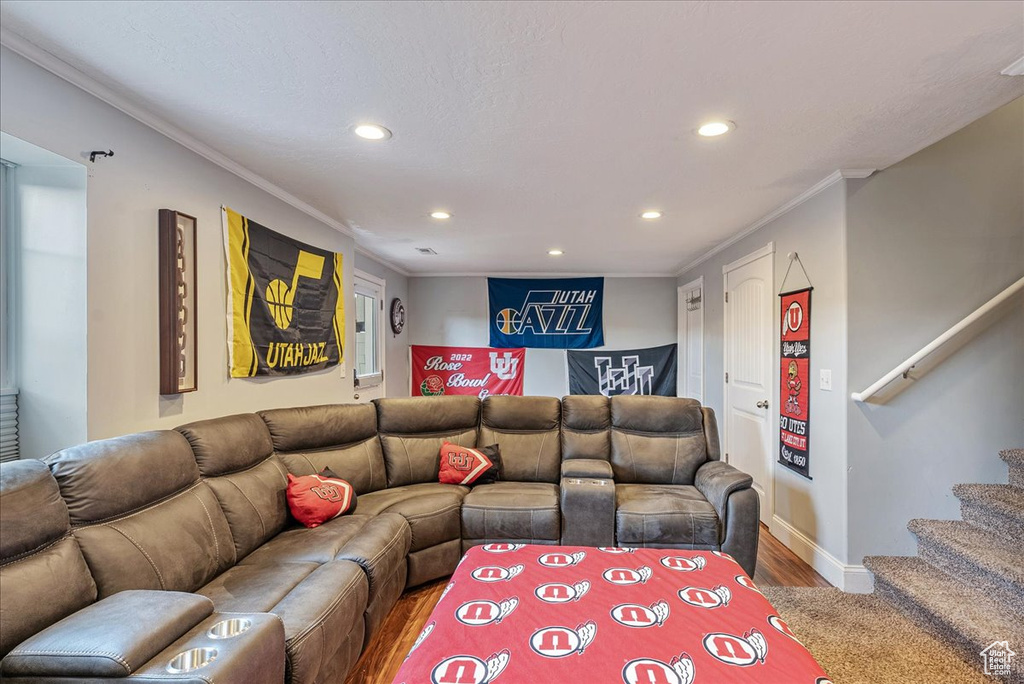 Living room featuring wood-type flooring and crown molding