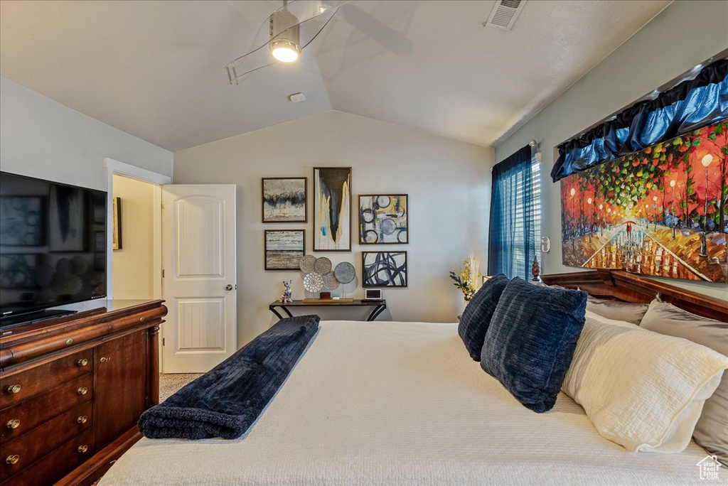 Bedroom with ceiling fan and lofted ceiling