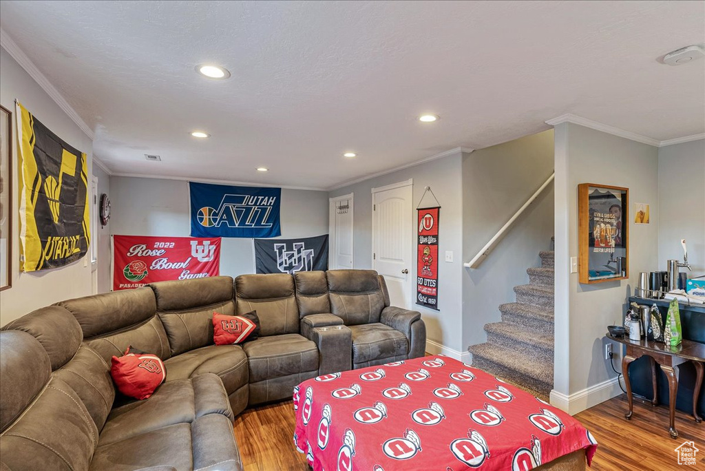 Living room with crown molding and hardwood / wood-style floors