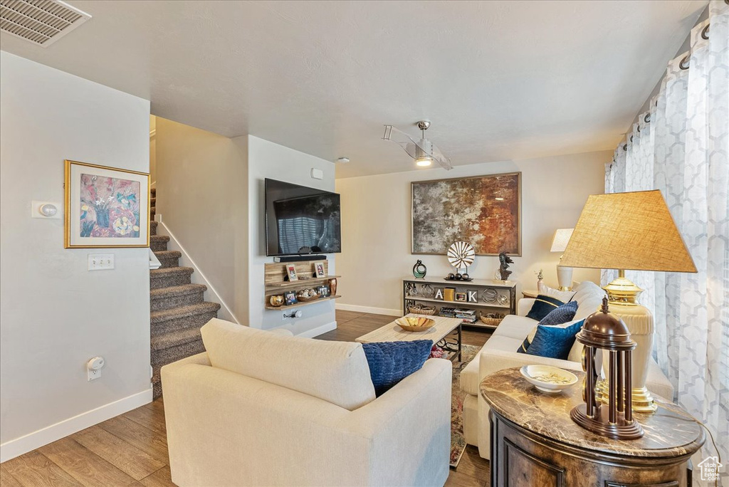 Living room with hardwood / wood-style flooring