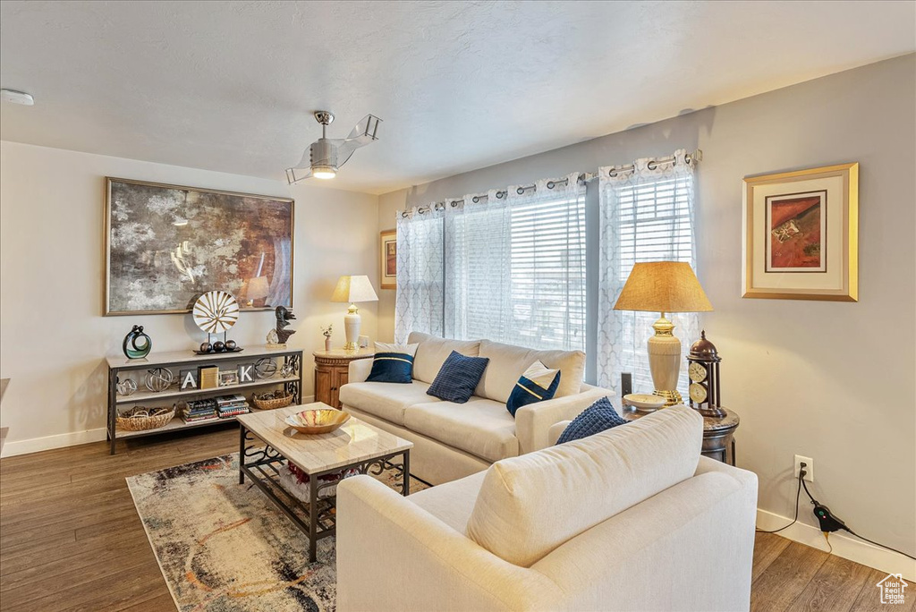 Living room with dark hardwood / wood-style flooring