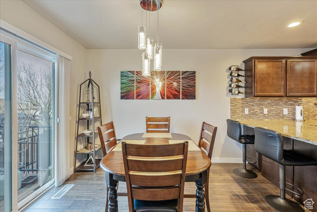 Dining space with dark wood-type flooring