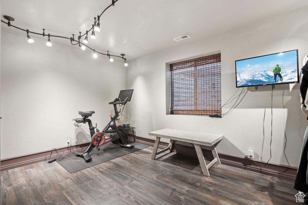 Exercise room with dark wood-type flooring