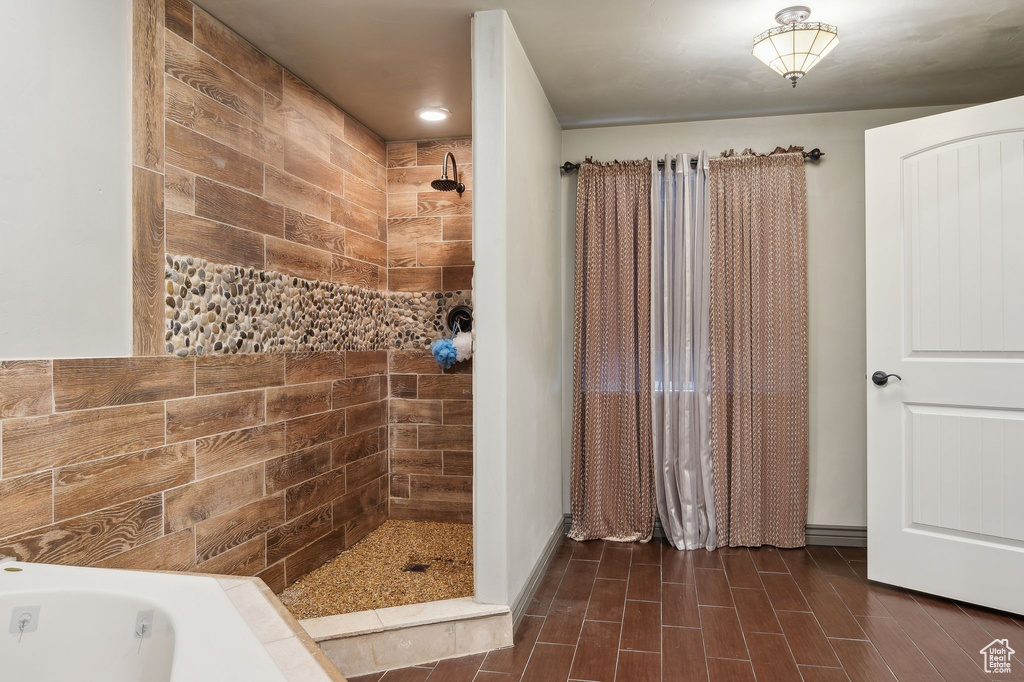 Bathroom featuring independent shower and bath and hardwood / wood-style flooring