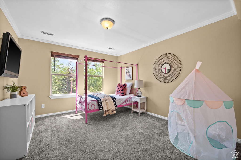 Carpeted bedroom with ornamental molding