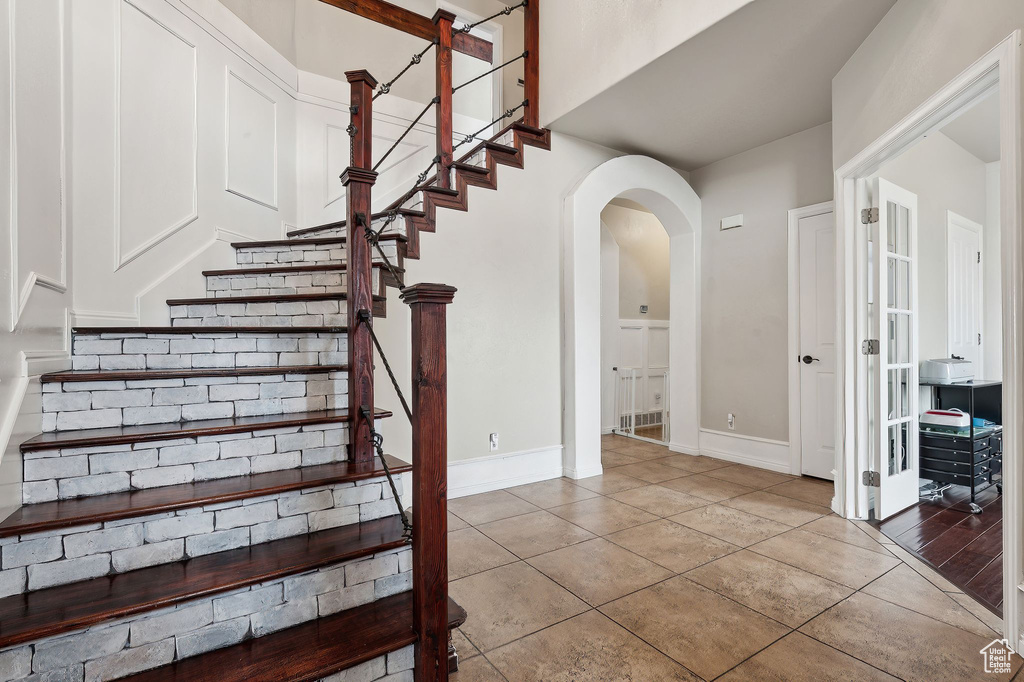Staircase featuring tile patterned floors