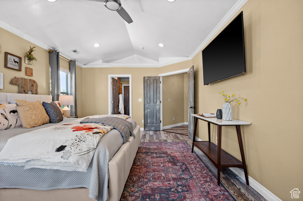 Bedroom featuring crown molding, lofted ceiling, and dark hardwood / wood-style floors