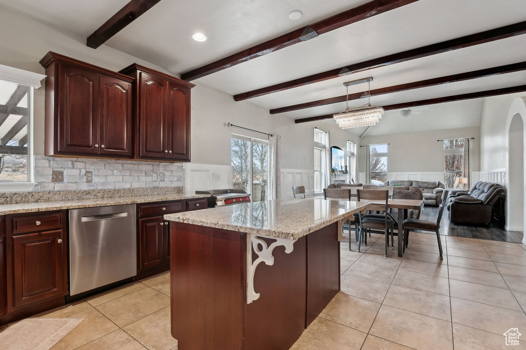 Kitchen with pendant lighting, light tile patterned floors, a center island, and dishwasher