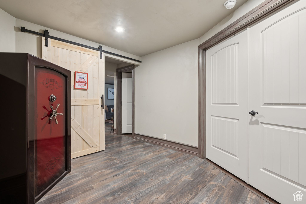 Interior space with dark hardwood / wood-style floors and a barn door