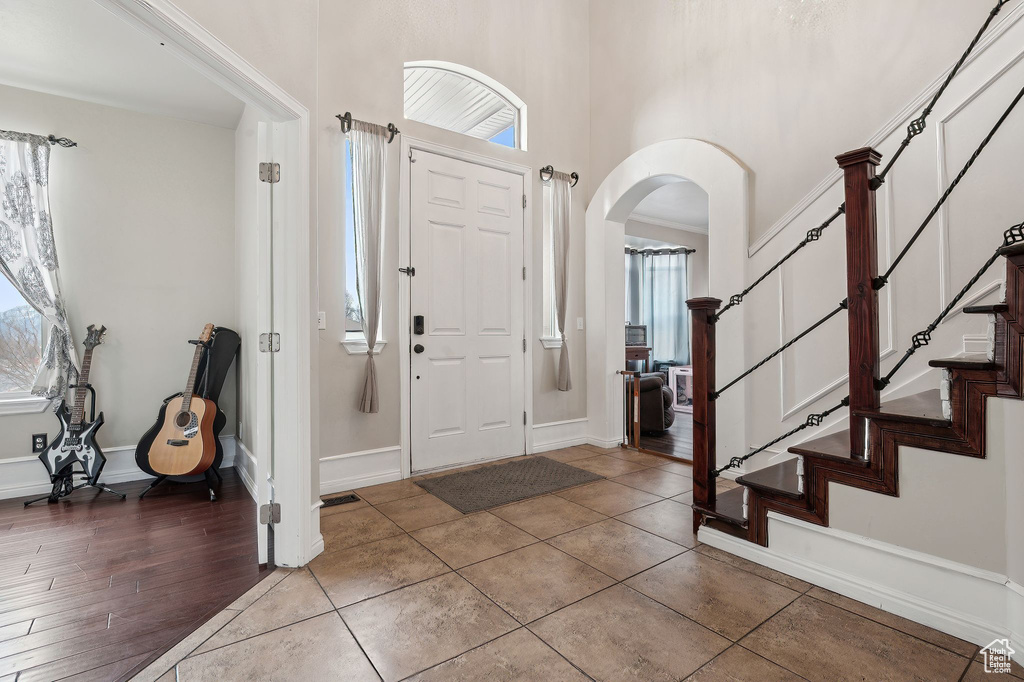 Tiled foyer with a high ceiling and plenty of natural light