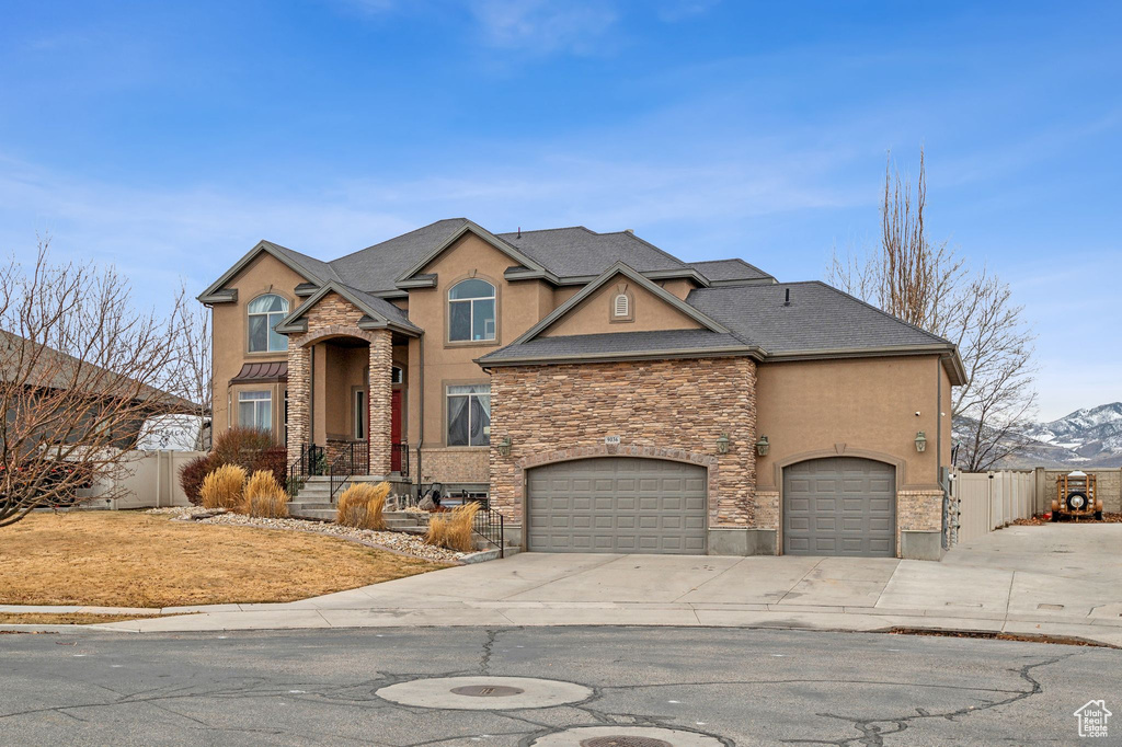 View of front facade featuring a mountain view and a garage