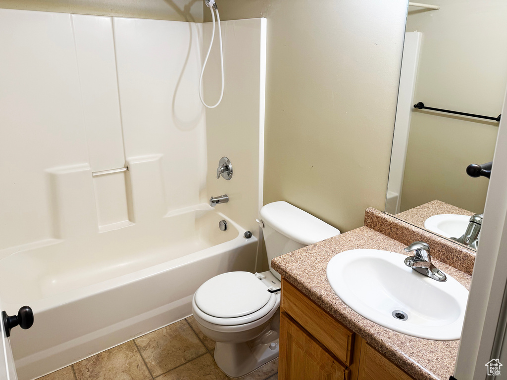 Full bathroom featuring shower / bath combination, vanity, and toilet