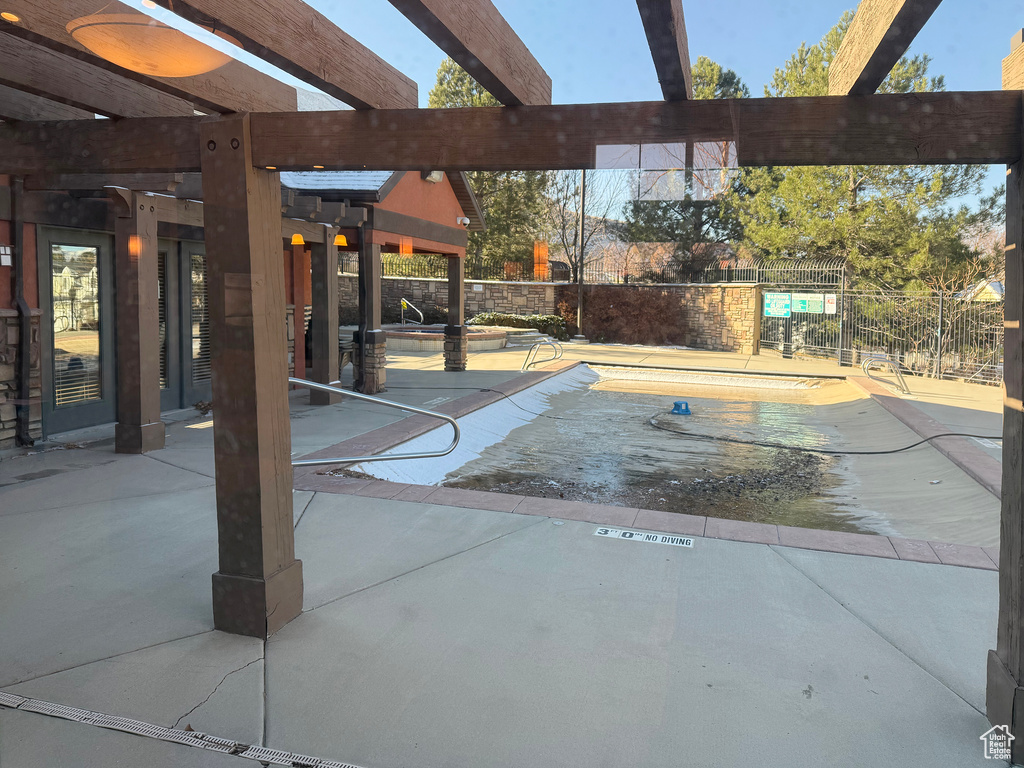 View of pool with a patio area and a pergola