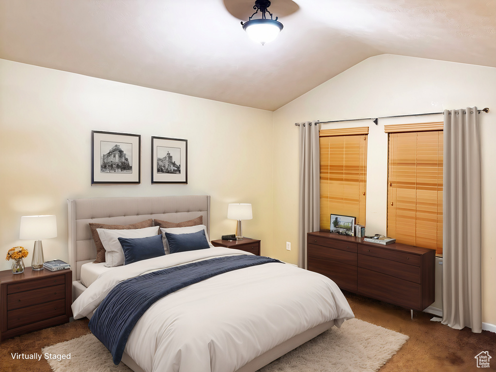 Carpeted bedroom featuring lofted ceiling