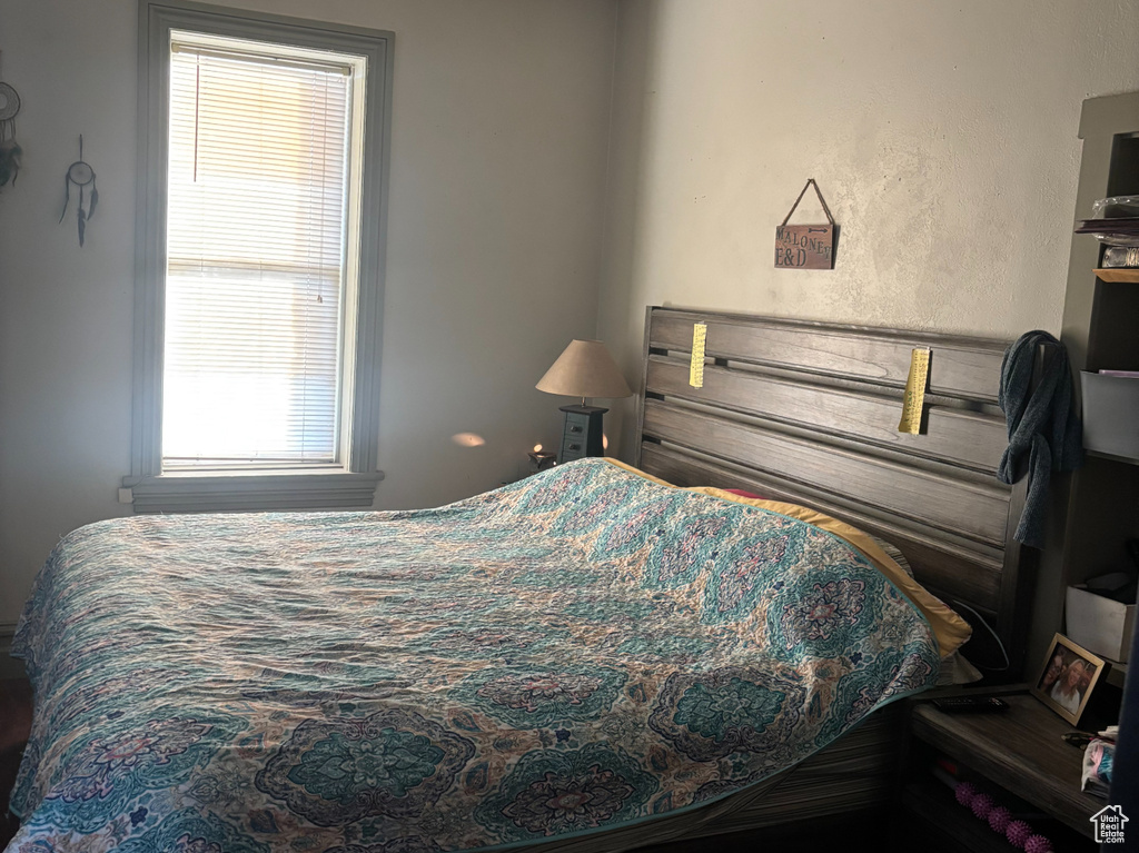 Bedroom with ceiling fan and a textured ceiling