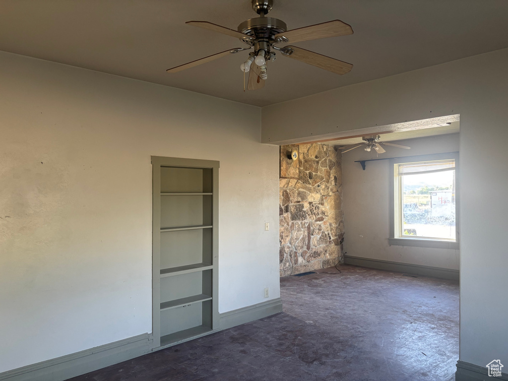 Unfurnished bedroom featuring a ceiling fan and baseboards