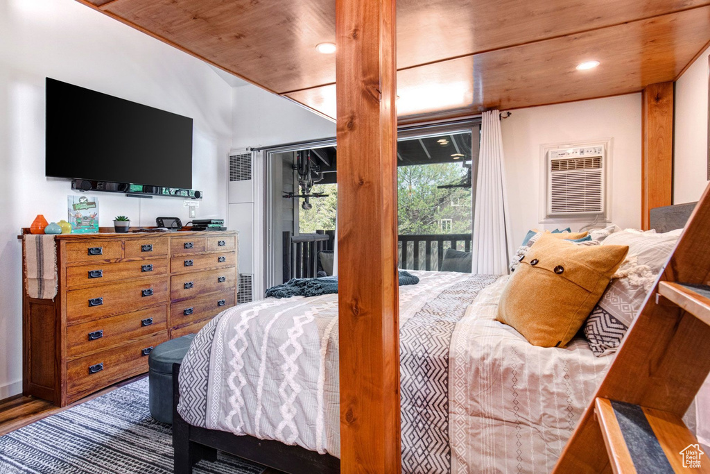 Bedroom featuring hardwood / wood-style flooring, access to exterior, and wood ceiling