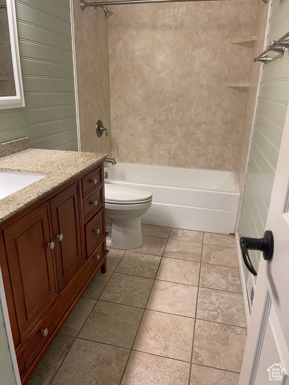 Full bathroom featuring vanity, tiled shower / bath combo, and toilet