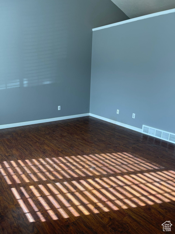 Unfurnished room featuring dark hardwood / wood-style flooring