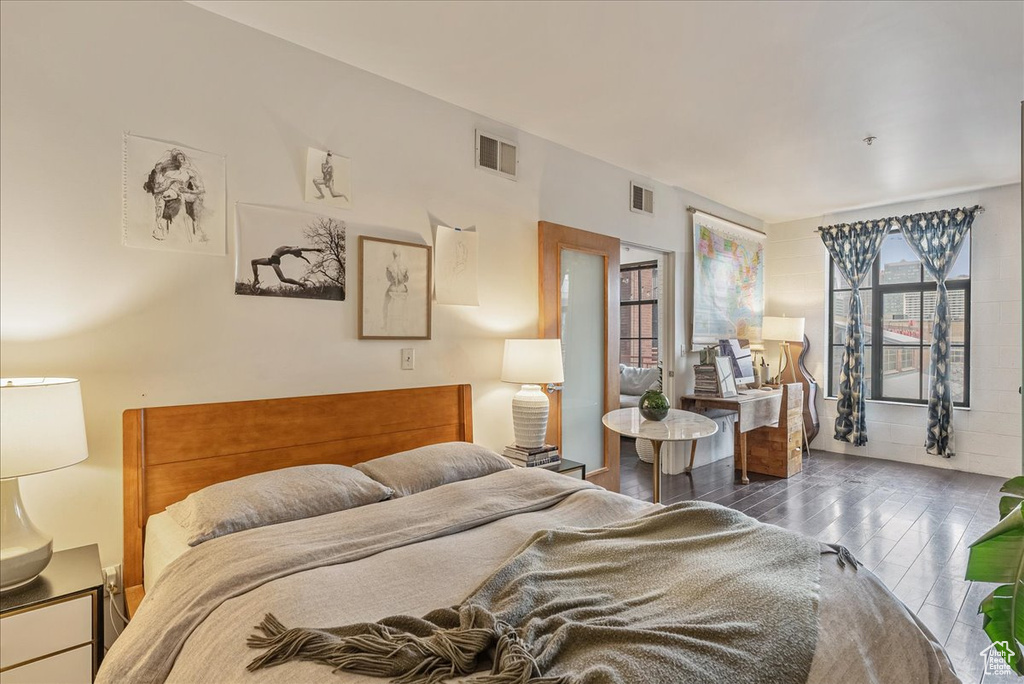 Bedroom with dark hardwood / wood-style floors