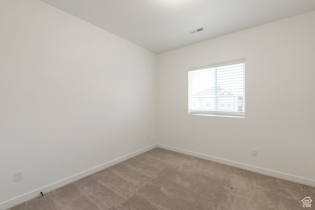 Unfurnished room with light carpet