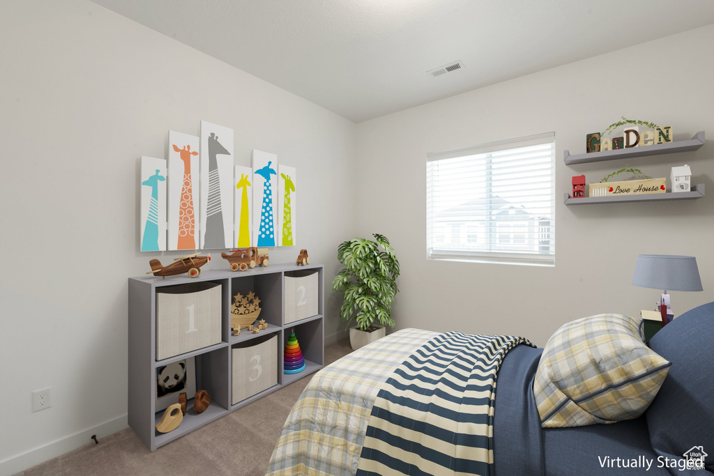 Bedroom featuring light colored carpet