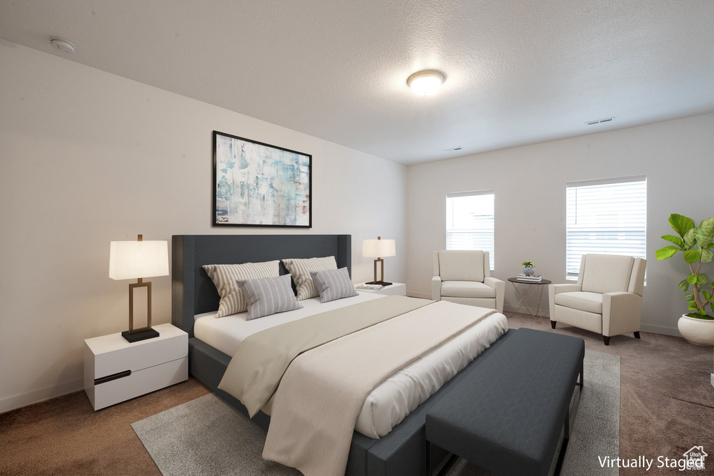 Bedroom with carpet and a textured ceiling