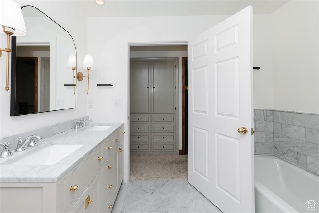 Bathroom with vanity and a bathing tub