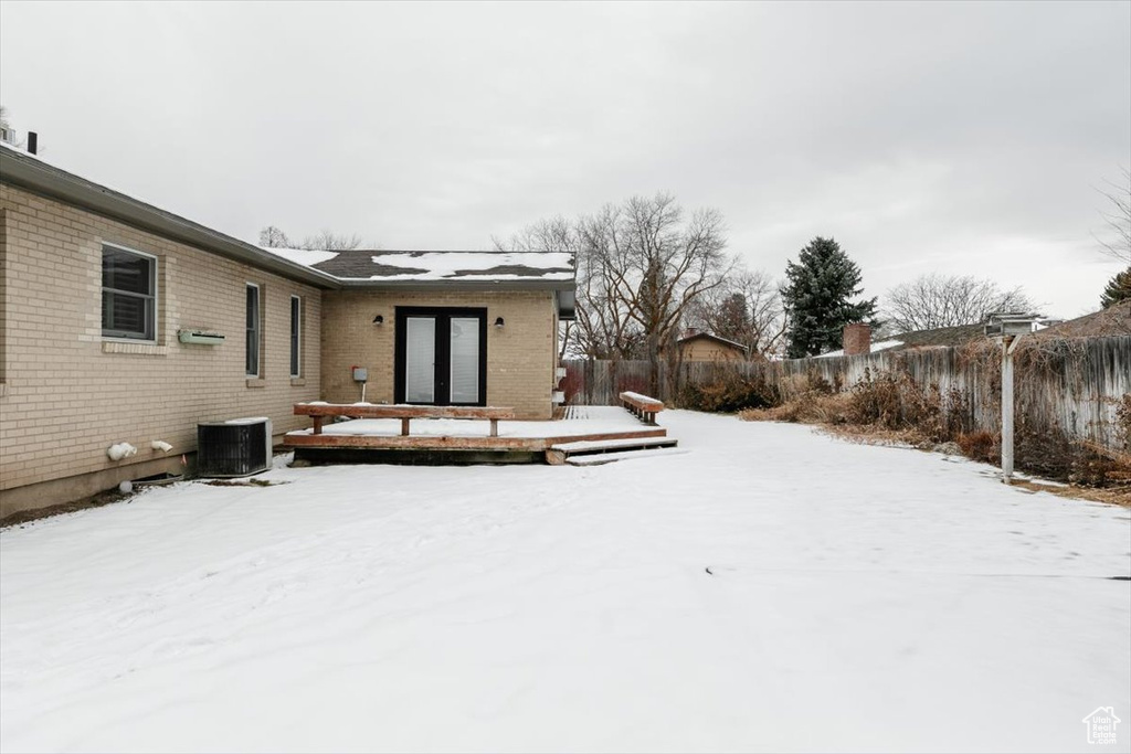 Yard covered in snow featuring central AC