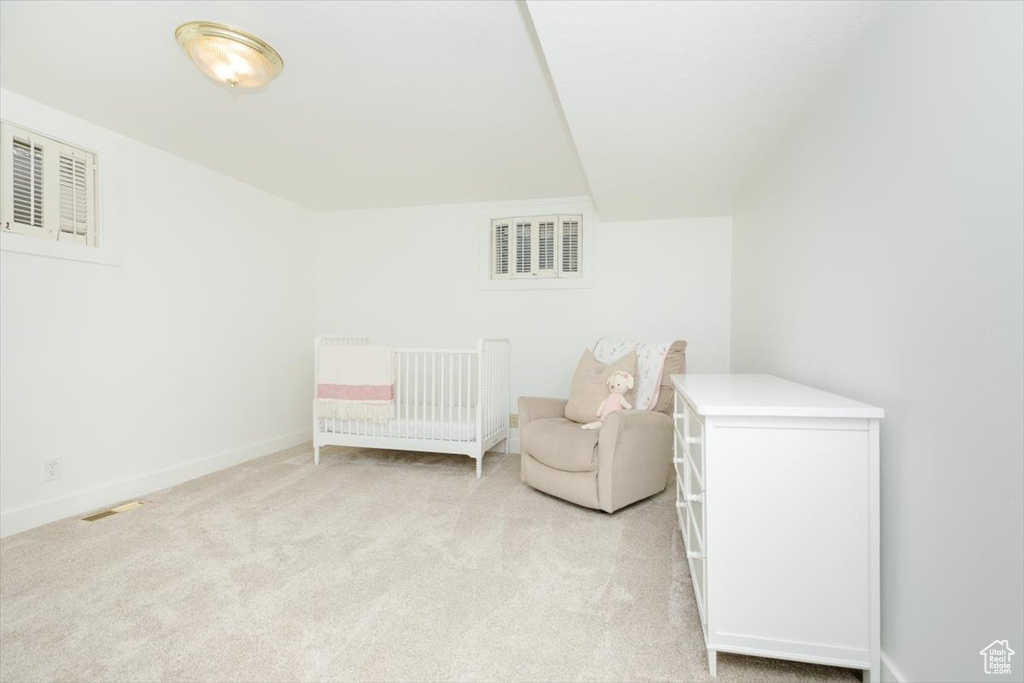 Carpeted bedroom with a crib