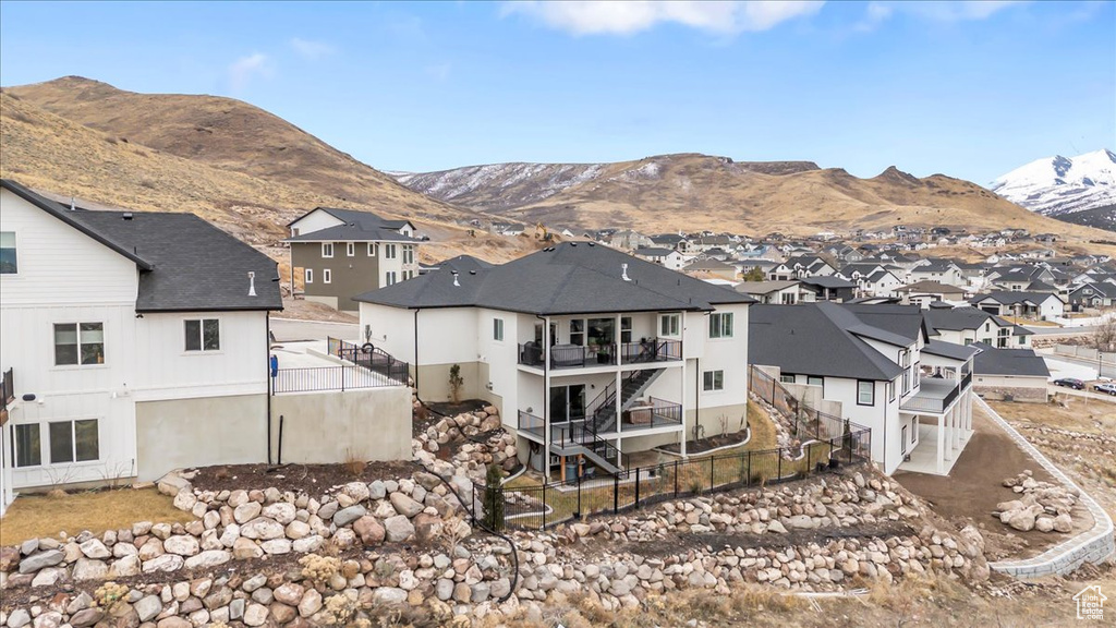 Rear view of property with a mountain view