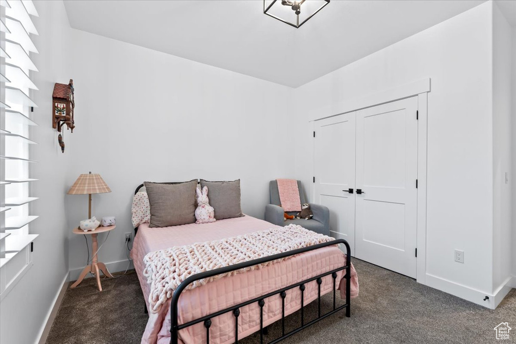 Carpeted bedroom with a closet