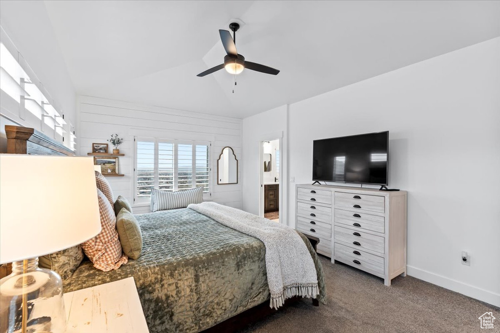 Carpeted bedroom featuring connected bathroom and ceiling fan