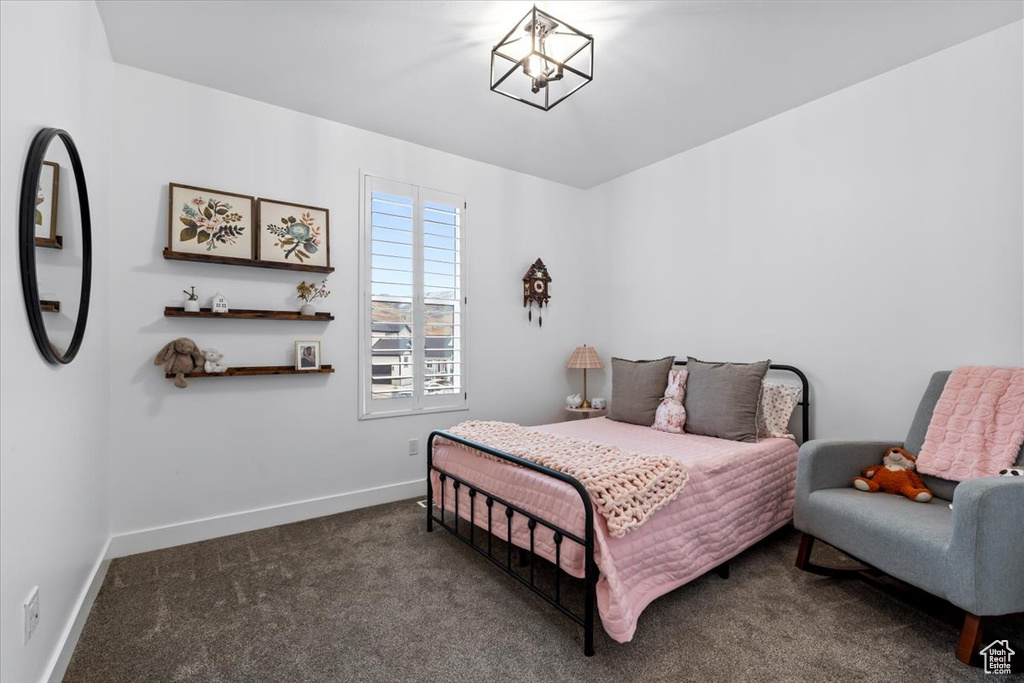 Bedroom with dark colored carpet