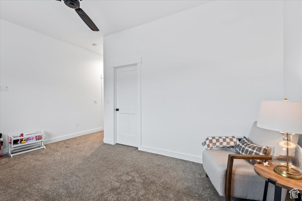 Sitting room with ceiling fan and carpet flooring