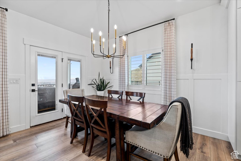 Dining room featuring a chandelier and light hardwood / wood-style floors