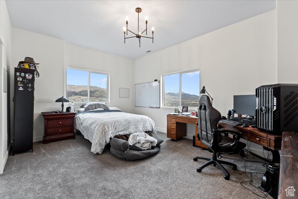 Carpeted bedroom featuring a chandelier