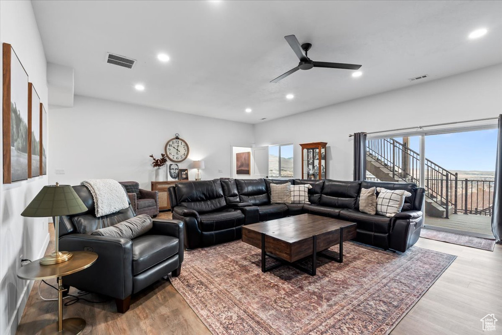 Living room with hardwood / wood-style flooring and ceiling fan