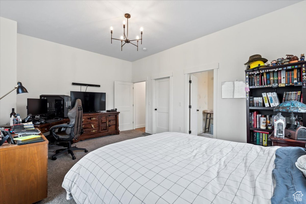 Bedroom featuring carpet and a notable chandelier