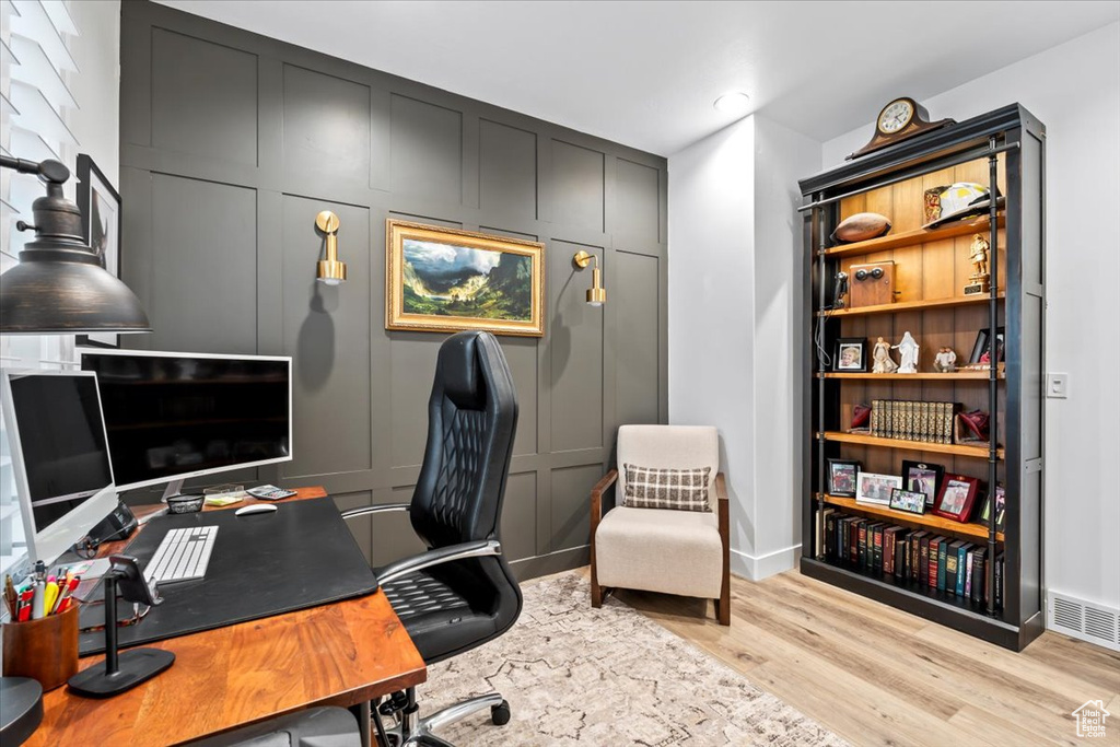 Office area with light wood-type flooring