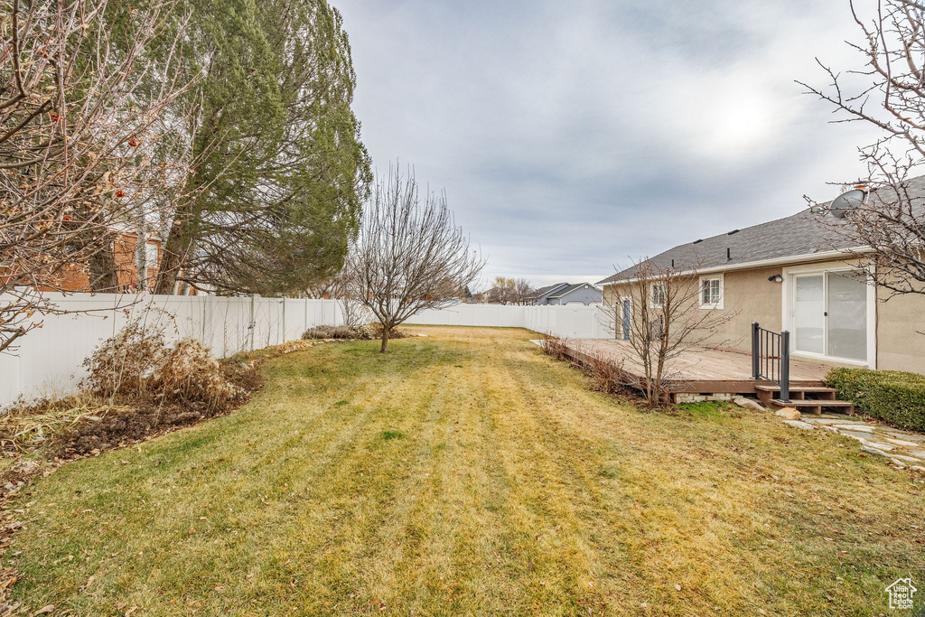 View of yard featuring a wooden deck