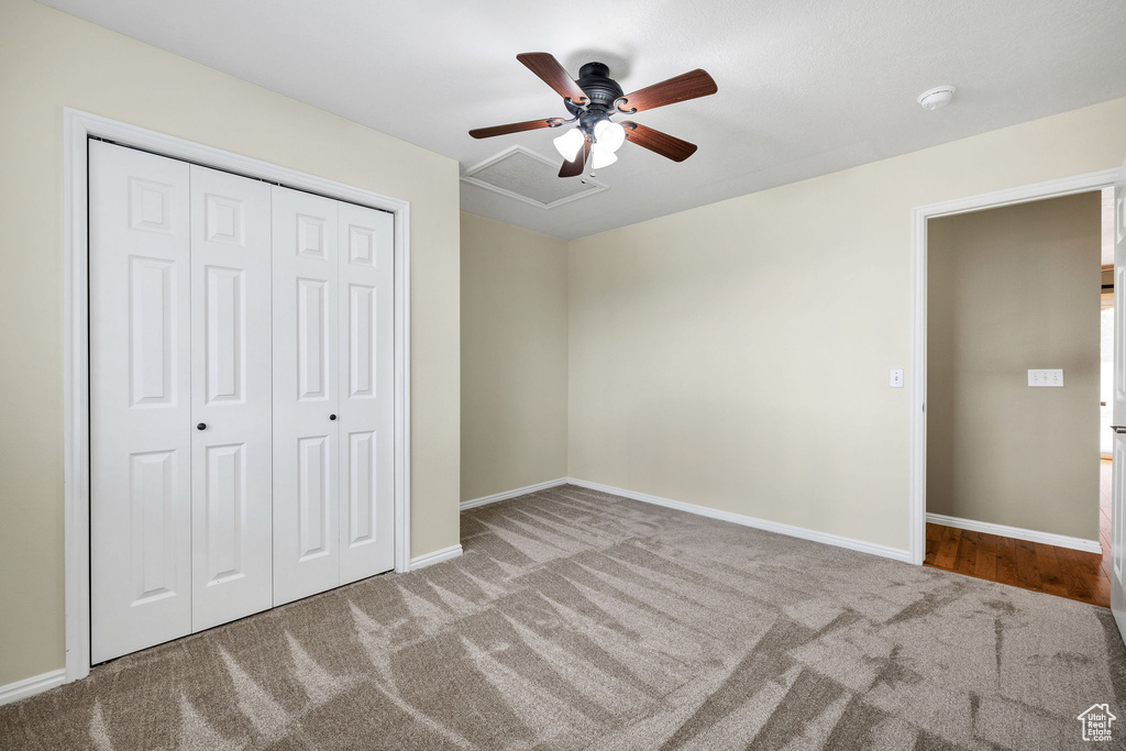 Unfurnished bedroom with light carpet, ceiling fan, and a closet