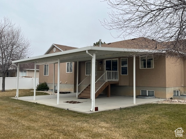 Rear view of house featuring a yard and a patio area